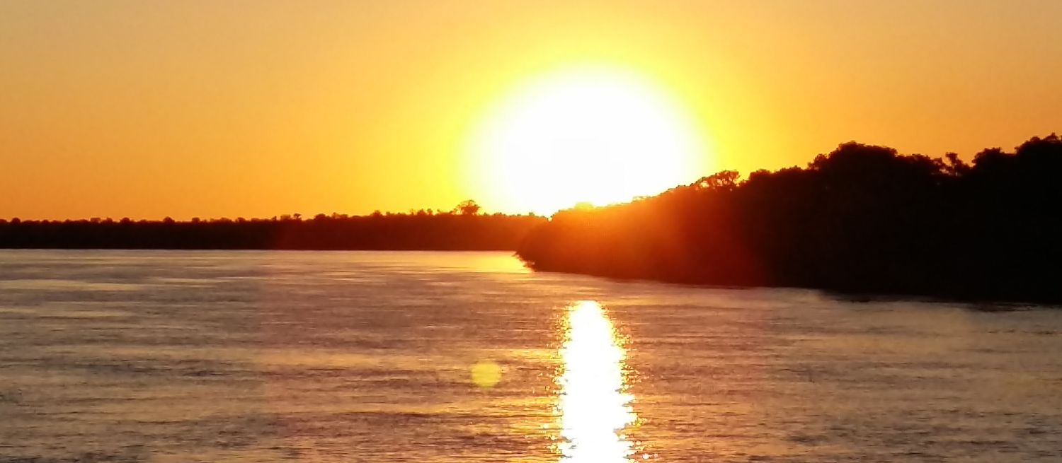Custome Touring at Victoria Falls, Zambezi River sunset